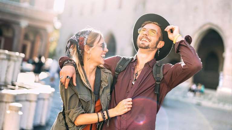 Happy couple smiles, eyes sparkling with joy and affection, capturing a beautiful moment together. 